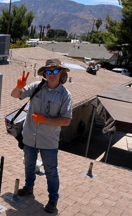 HVAC technician standing on a residential rooftop