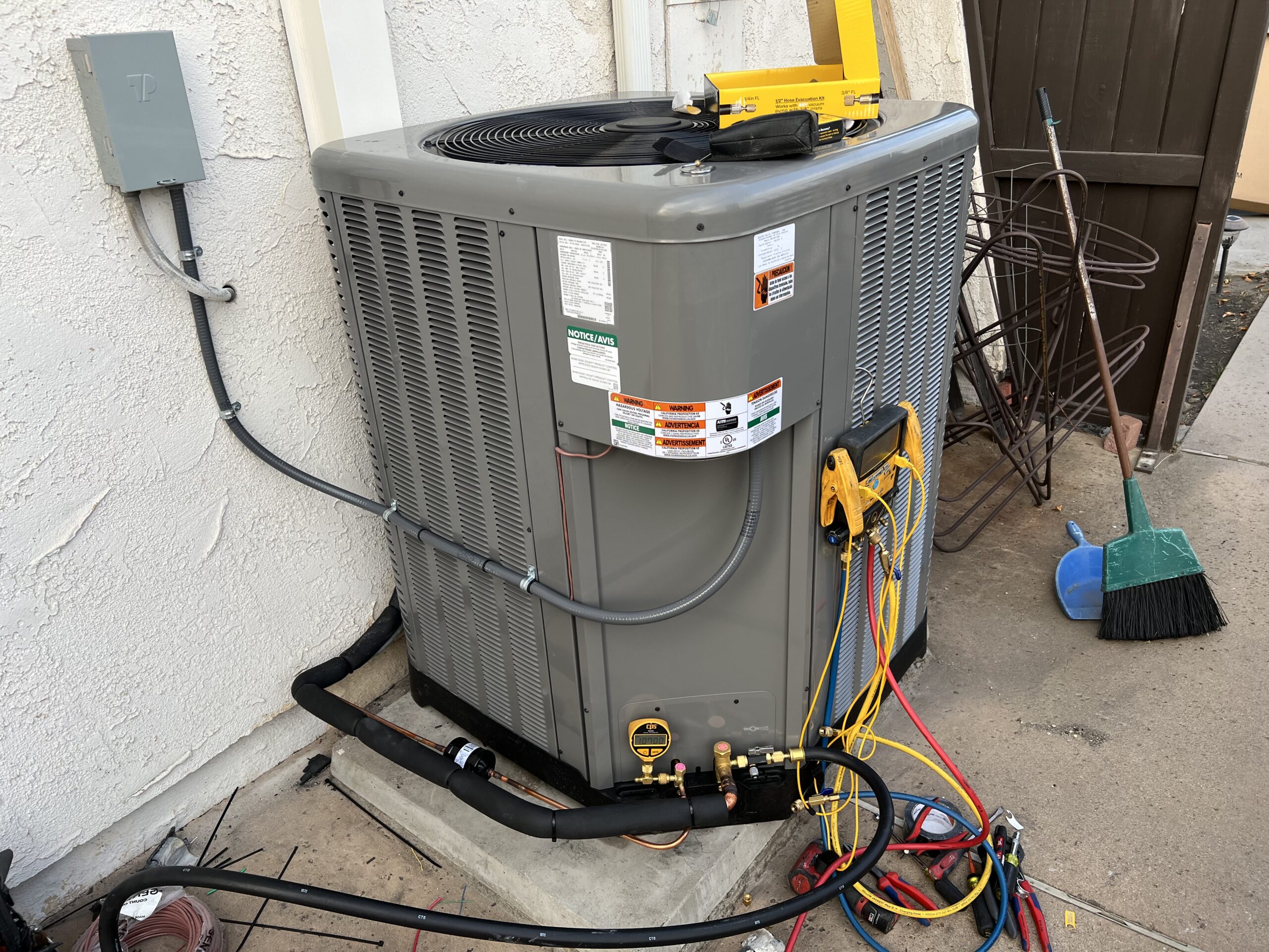 Air conditioning condenser with gauges connected for service